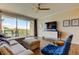 Living room featuring wood flooring, stylish furniture, and sliding glass doors leading to a balcony at 129 Brent Cir, Oldsmar, FL 34677