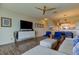 Inviting living room featuring sleek furniture, a large TV, and a seamless flow into the dining area at 129 Brent Cir, Oldsmar, FL 34677