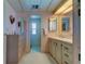 Bright bathroom with double vanity and mirrored medicine cabinets at 402 Blue Marlin Dr, Oldsmar, FL 34677
