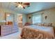 Main bedroom with a dresser, ensuite bathroom access, and a ceiling fan at 402 Blue Marlin Dr, Oldsmar, FL 34677