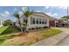 Charming single-wide manufactured home with landscaped front yard and palm trees at 402 Blue Marlin Dr, Oldsmar, FL 34677