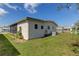 Side view of the house showing landscaping and AC unit at 402 Blue Marlin Dr, Oldsmar, FL 34677