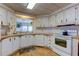 Efficient kitchen with white cabinets, ample counter space, and modern appliances at 402 Blue Marlin Dr, Oldsmar, FL 34677