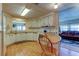 Galley-style kitchen with white cabinets and wood-look flooring at 402 Blue Marlin Dr, Oldsmar, FL 34677