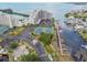 Stunning aerial view of the waterfront condo, tennis courts, and private boat docks on a sunny day at 6035 Sea Ranch Dr # 505, Hudson, FL 34667