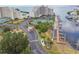 Aerial view of a condo community featuring tennis courts, docks, palm trees and a grand entrance at 6035 Sea Ranch Dr # 505, Hudson, FL 34667
