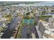 Aerial view showcases tennis courts, parking, and boat docks, complementing waterfront condo living at 6035 Sea Ranch Dr # 505, Hudson, FL 34667