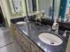 Bathroom featuring a double vanity with granite countertop and modern fixtures with a neutral color palette at 6035 Sea Ranch Dr # 505, Hudson, FL 34667
