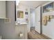 Bathroom with a white vanity, framed mirror, and wood-look floors at 6035 Sea Ranch Dr # 505, Hudson, FL 34667