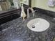 Close up of bathroom sink with stainless fixtures and a dark granite countertop at 6035 Sea Ranch Dr # 505, Hudson, FL 34667