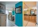 View from the hall showing the spacious main bedroom with turquoise walls and an ensuite bathroom at 6035 Sea Ranch Dr # 505, Hudson, FL 34667