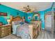 Bright bedroom featuring detailed wood trim, a ceiling fan, and a doorway leading to the bathroom at 6035 Sea Ranch Dr # 505, Hudson, FL 34667