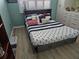 Charming bedroom with nautical decor, a comfortable bed, and ample storage space in a cozy setting at 6035 Sea Ranch Dr # 505, Hudson, FL 34667