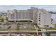 An exterior view shows a luxurious waterfront condominium with boat docks and lush landscaping at 6035 Sea Ranch Dr # 505, Hudson, FL 34667