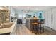 Modern kitchen with white cabinets, center island with seating, and stainless steel appliances. Open floor plan at 6035 Sea Ranch Dr # 505, Hudson, FL 34667
