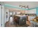 Modern kitchen with white cabinets, center island with seating, and stainless steel appliances. Open floor plan at 6035 Sea Ranch Dr # 505, Hudson, FL 34667