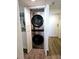Hallway laundry closet with a stacked washer and dryer unit at 6035 Sea Ranch Dr # 505, Hudson, FL 34667