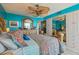 Bright bedroom with decorative accents, ceiling fan and mirrorred wardrobe at 6035 Sea Ranch Dr # 505, Hudson, FL 34667