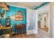 Office or den features wood-look floors, french door, and bright blue accent wall with decorations at 6035 Sea Ranch Dr # 505, Hudson, FL 34667