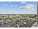 Elevated view of a well maintained parking lot, waterways, tennis courts and houses beyond at 6035 Sea Ranch Dr # 505, Hudson, FL 34667