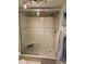 Shower featuring a glass door, built in bench, a rain shower head and pebble flooring at 6035 Sea Ranch Dr # 505, Hudson, FL 34667