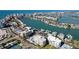 Aerial view of condo community by the water with boat docks and cityscape views at 830 S Gulfview Blvd # 305, Clearwater Beach, FL 33767