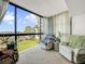 Inviting sunroom with comfortable seating, large window, and bright natural light at 830 S Gulfview Blvd # 305, Clearwater Beach, FL 33767