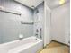 Tiled bathroom with a shower-tub combo and a white shower curtain rod at 830 S Gulfview Blvd # 305, Clearwater Beach, FL 33767