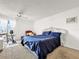 Spacious bedroom with a large window, stationary bike, and ornamental headboard at 830 S Gulfview Blvd # 305, Clearwater Beach, FL 33767