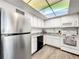 Efficient kitchen with stainless steel refrigerator, white cabinets, and natural lighting at 830 S Gulfview Blvd # 305, Clearwater Beach, FL 33767