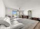 Inviting living room with white sofa, light-colored carpet, and outdoor view from balcony at 830 S Gulfview Blvd # 305, Clearwater Beach, FL 33767