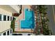 Top down aerial of outdoor pool with lounge chairs and manicured tropical landscaping at 830 S Gulfview Blvd # 305, Clearwater Beach, FL 33767