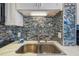 Modern kitchen sink with a stylish backsplash at 6035 Sea Ranch Dr # 505, Hudson, FL 34667