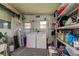 Laundry room with washer, dryer and storage shelves at 402 Blue Marlin Dr, Oldsmar, FL 34677