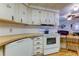 Curved kitchen with white cabinets and a modern oven at 402 Blue Marlin Dr, Oldsmar, FL 34677