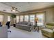 Living room with floral patterned sofa, light colored recliner, and view to outside at 402 Blue Marlin Dr, Oldsmar, FL 34677
