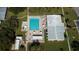 Aerial view of community pool with lounge chairs and surrounding landscape at 402 Blue Marlin Dr, Oldsmar, FL 34677