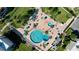 Aerial view of a resort-style pool and deck with ample lounge chairs and umbrellas at 830 S Gulfview Blvd # 305, Clearwater Beach, FL 33767
