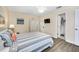 Main bedroom with a comfortable bed, TV, and coastal decor at 260 Medallion Blvd # F, Madeira Beach, FL 33708