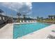 Community swimming pool with lounge chairs at 1750 Harbor S Pl # 103, South Pasadena, FL 33707