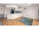 Living room features hardwood floors and access to kitchen at 1750 Harbor S Pl # 103, South Pasadena, FL 33707