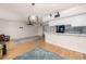 Bright living room with wood floors, ceiling fan, and access to a balcony at 1750 Harbor S Pl # 103, South Pasadena, FL 33707