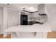 Modern kitchen with dark cabinetry and breakfast bar at 1750 Harbor S Pl # 103, South Pasadena, FL 33707
