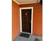 Dark brown front door with white trim on an orange building at 10200 Gandy N Blvd # 816, St Petersburg, FL 33702