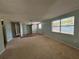 Spacious living room with carpeted floors and large window at 5060 86Th Ave N, Pinellas Park, FL 33782