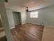 Bright bedroom featuring wood-look flooring and built-in shelves at 5060 86Th Ave N, Pinellas Park, FL 33782