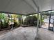 Cozy screened porch with a concrete floor and small garden at 5060 86Th Ave N, Pinellas Park, FL 33782