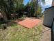 Brick patio in backyard, surrounded by grass and trees at 5060 86Th Ave N, Pinellas Park, FL 33782