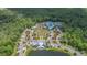 An aerial view of the Community Center, swimming pools, walking paths, and clubhouse among lush trees at 16701 Vibrato Ln, Land O Lakes, FL 34638