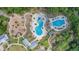 Community resort style pools with lounge chairs, and a playground surrounded by beautiful Florida landscape at 16701 Vibrato Ln, Land O Lakes, FL 34638